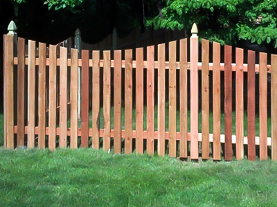 Custom natural wood picket fence around backyard